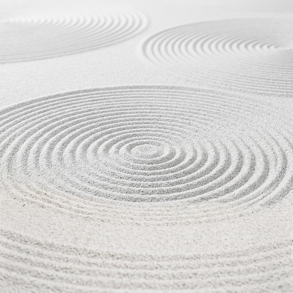 Three stones surrounded by circular patterns in a Japanese rock garden